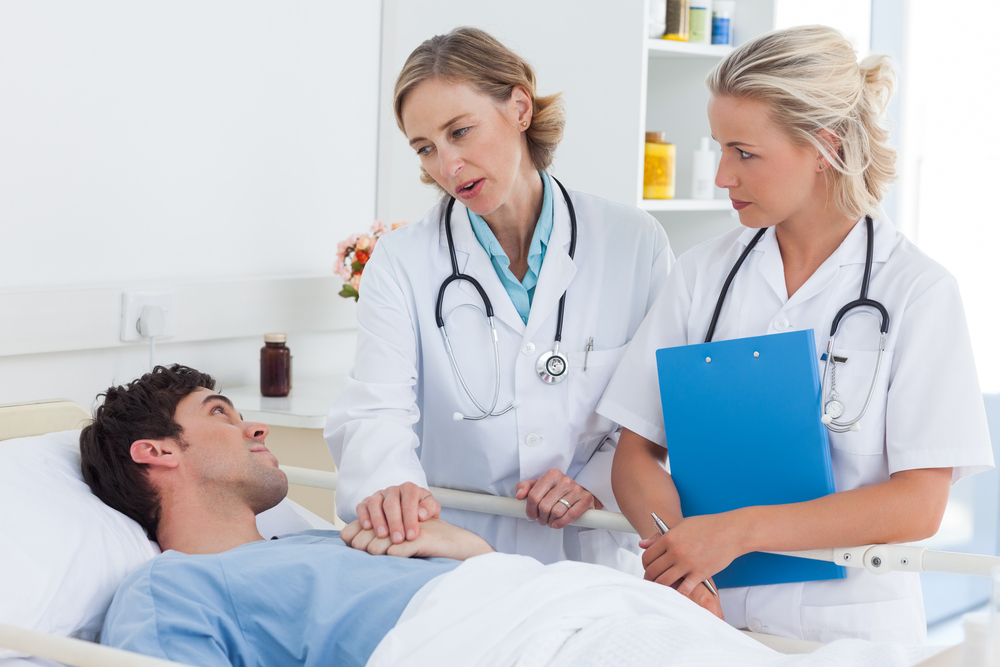 Doctors Talking To A Patient In Hospital